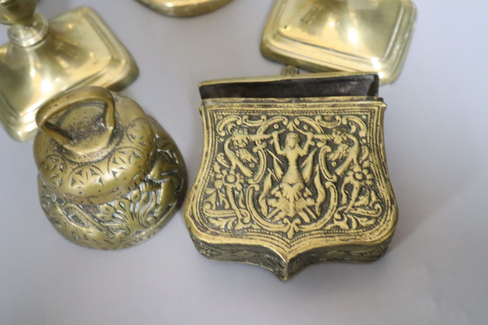 A group of brassware including candlesticks